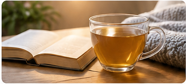 Cup of herbal tea beside a book during a calming bedtime routine.